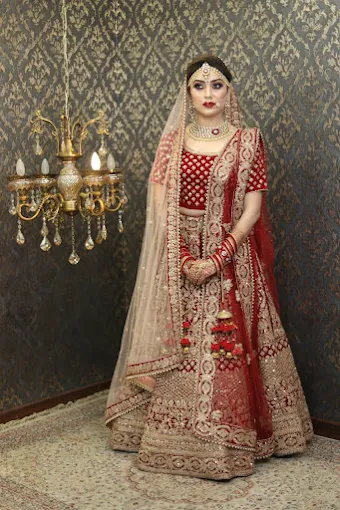 Bride in red lehenga after full bridal hair and makeup at the salon
