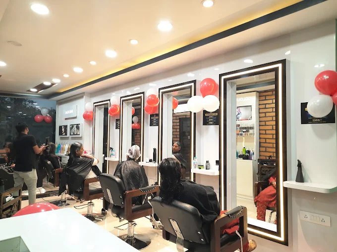 Styling stations with lit mirrors inside Sri Professional salon, Barwadih